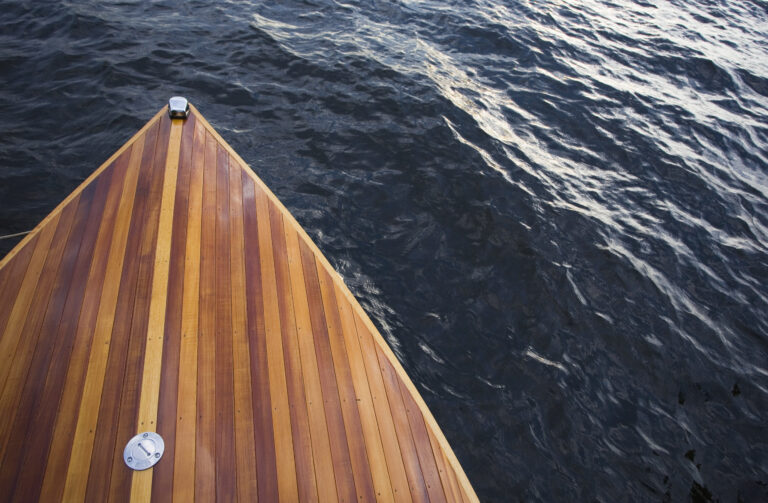 USA, New York State, wooden bow of boat on water, elevated view